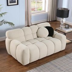 a white couch sitting on top of a hard wood floor