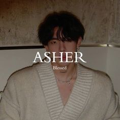 a person wearing a white sweater with the words asher in front of them and an image of a woman's face