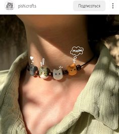 an image of a woman wearing a necklace with cats on the bead and words that say meow