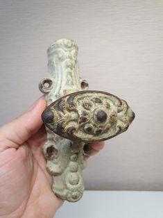 a hand holding a piece of pottery in it's palm