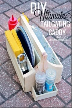 a wooden box filled with crafting supplies on top of a brick floor and the words diy ultimate tailgating caddy