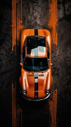 an orange sports car painted in black and white stripes on a dark background with paint splatters