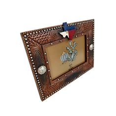 a wooden frame with an american flag and cactus design on it, hanging from the wall