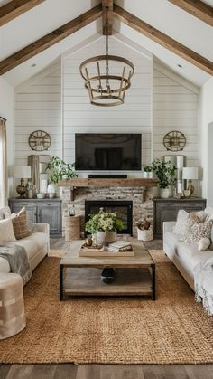 a living room filled with furniture and a flat screen tv mounted on the wall above a fireplace