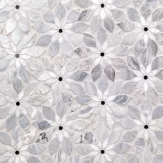 an image of a white and black flower pattern on glass tile wallpaper with dots in the center