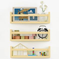 two wooden shelves with books and pictures on them, one shelf has an alarm clock