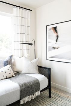 a living room with a couch, rug and pictures hanging on the wall above it