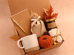 a box filled with coffee, yarn and other items on top of a white table