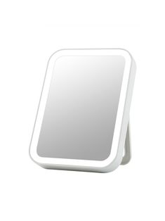 a white square mirror sitting on top of a table