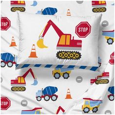 a bed with construction vehicles and stop signs on it