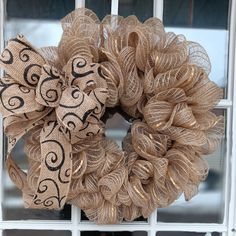 a close up of a burlock wreath on a window sill in front of a building