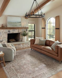 a living room filled with furniture and a fire place in the middle of an open floor plan