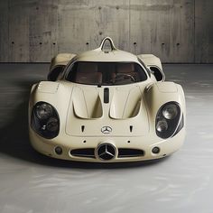 a white mercedes sports car parked in a garage