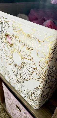 the drawers are decorated with gold and white flowers