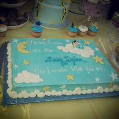 there is a blue cake with stars and clouds on it