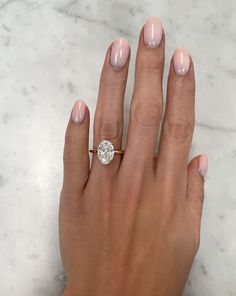 a woman's hand with a diamond ring on it