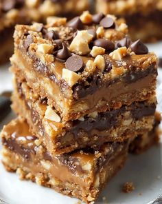 three pieces of chocolate peanut butter bars stacked on top of each other