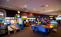 several arcade machines in a large room