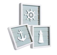 three framed pictures with an anchor, lighthouse and ship wheel