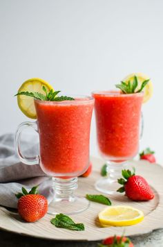 two glasses filled with strawberry lemonade and garnish