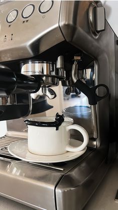 an espresso machine with two cups on it