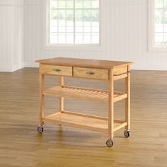 a kitchen island with two drawers and wheels on the bottom shelf in an empty room