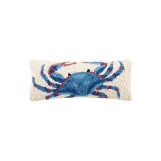 a blue crab pillow on a white background