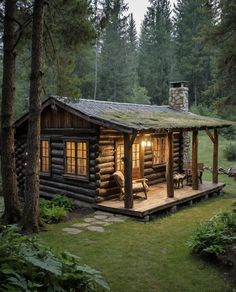 a log cabin in the woods with lights on