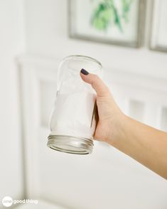 a person holding a glass jar with something in it