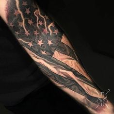 a man's arm with an american flag tattoo on it