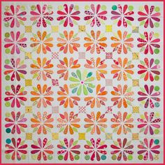 a colorful quilt with flowers on it