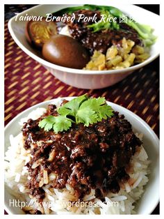 two white plates topped with rice and meat covered in gravy, garnished with cilantro