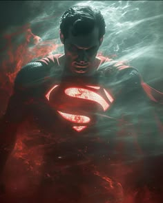 a man in a superman suit with flames around his chest and arms, standing in front of a dark background