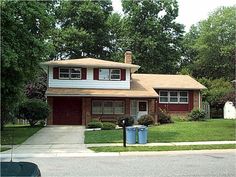 a red house sitting on the corner of a street