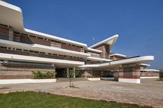 the building has many windows and is made out of brick, with multiple levels on each level