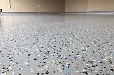 the floor is shiny with blue and white confetti flakes on it's surface