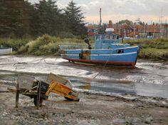 there are two boats on the shore and one is sitting in the water with it's seat up