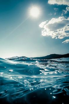 the sun is shining above the ocean water