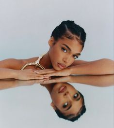 an image of a woman with her reflection in the water