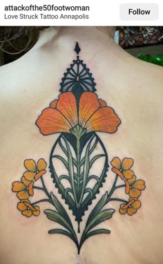 the back of a woman's tattoo with orange flowers on her upper and chest