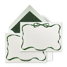 three blank cards with green ink on them