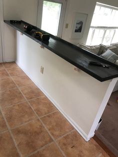 a kitchen counter with wine bottles on it