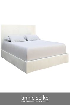 an image of a bed with white linens and pillows on the headboard that says annie selke