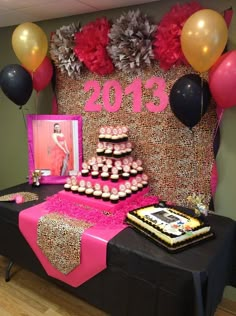 a table topped with lots of cakes and cupcakes