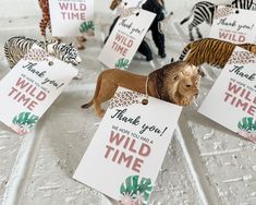 small figurines of wild animals holding signs with thank you and wild time written on them