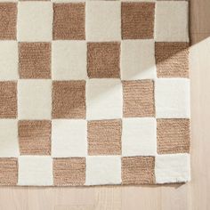 a brown and white checkered rug on the floor