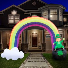 a st patrick's day lawn decoration with a rainbow in front of a house