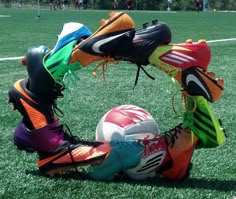 a soccer goalie's gear and ball on the grass in front of an open field