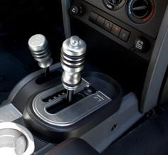 an automatic gear box in a car with the control knobs and manual controls on