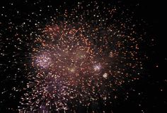 fireworks are lit up in the night sky with bright colors and sparkles all around